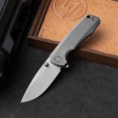 Olitans Bomber 2.0 T065 - 2.95" M390 Stonewashed Blade, Dark Grey Titanium Handle