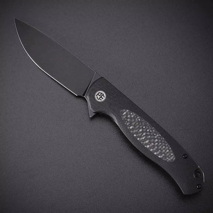 Petrified Fish Stamp PFB03 - 3.58" D2 Black Stonewashed Blade, Black G10 With Carbon Fibre Handle, Flipper