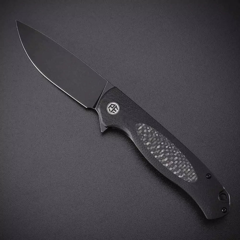 Petrified Fish Stamp PFB03 - 3.58" D2 Black Stonewashed Blade, Black G10 With Carbon Fibre Handle, Flipper